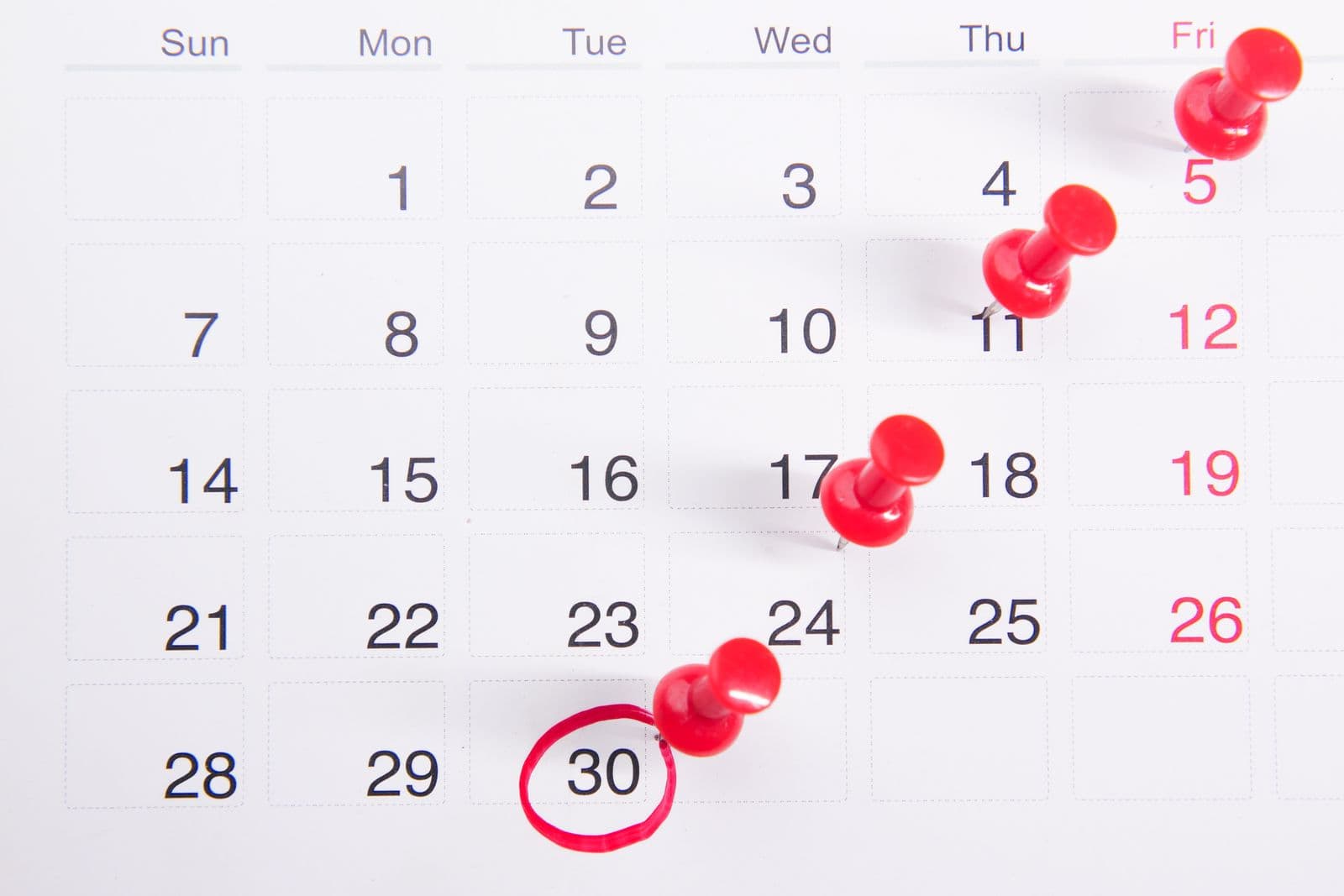 A calendar with red pins marking a sequence of upcoming dates